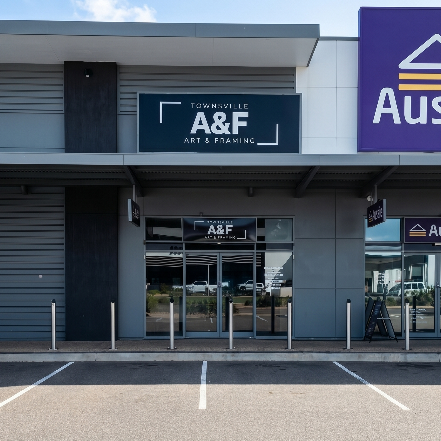 Commercial building with 'A&F' and 'Aussie' signs on a clear day.
